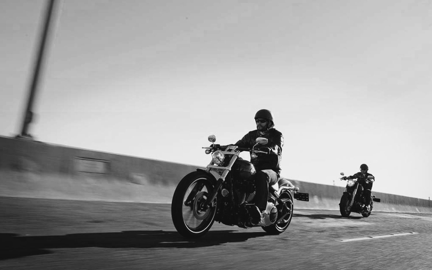 Two riders on an open highway